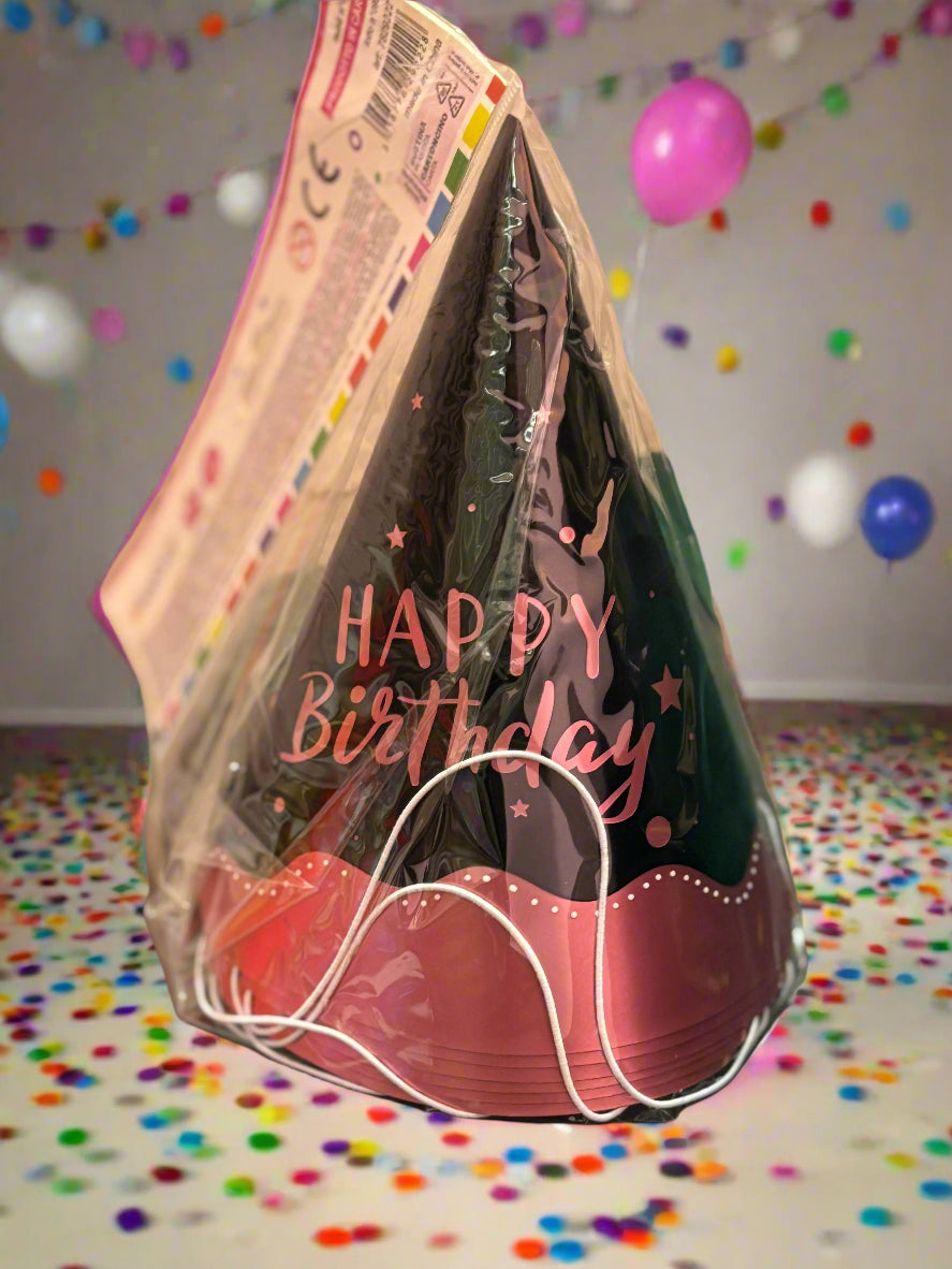A collection of children’s party hats in black and pink: alternating matte black cone hats and bright pink cone hats with white polka‑dot patterns