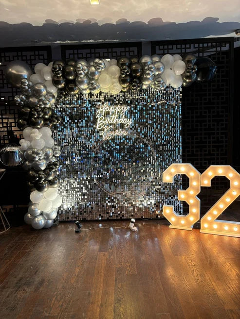 Silver Sequin Backdrop with Silver & Black Balloon Garland for Birthday Decor | The Party Store